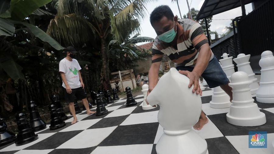 Warga bermain catur raksasa di Pondok Betung, Tangerang Selatan, Banten, Indonesia, Selasa (19/5/2020). Hal itu guna mengisi kegiatan jelang berbuka puasa sekaligus berolahraga di tengah pandemi COVID-19. (CNBC Indonesia/ Andrean Kristianto)