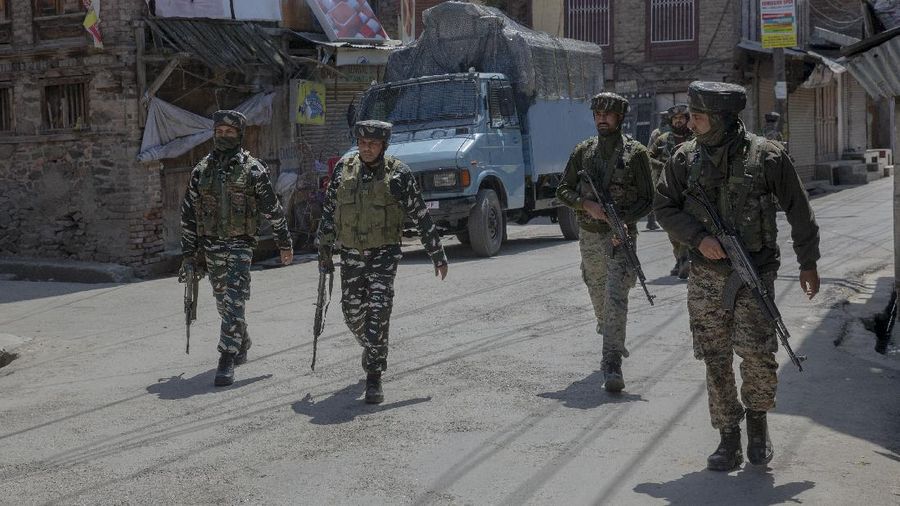 Indian paramilitary soldiers walk back towards their vehicles after a gun battle with suspected rebels ended in Srinagar, Indian controlled Kashmir, Tuesday, May 19, 2020. Indian government forces killed two rebels in disputed Kashmir on Tuesday and shut down cellphone and mobile internet services during subsequent anti-India protests, officials and residents said. (AP Photo/ Dar Yasin)