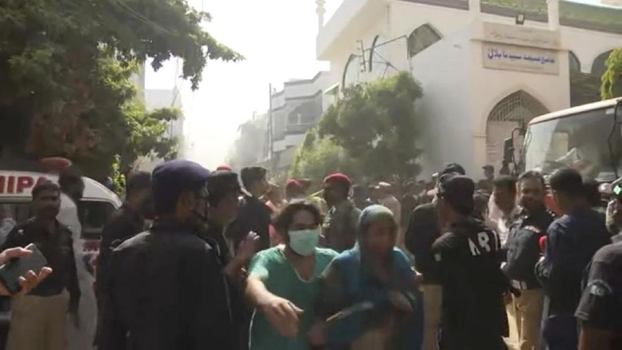 A firefighter tries to put out fire caused by plane crash in Karachi, Pakistan, Friday, May 22, 2020. An aviation official says a passenger plane belonging to state-run Pakistan International Airlines carrying more than 100 passengers and crew has crashed near the southern port city of Karachi. There were no immediate reports on the number of casualties. (AP Photo/Fareed Khan)