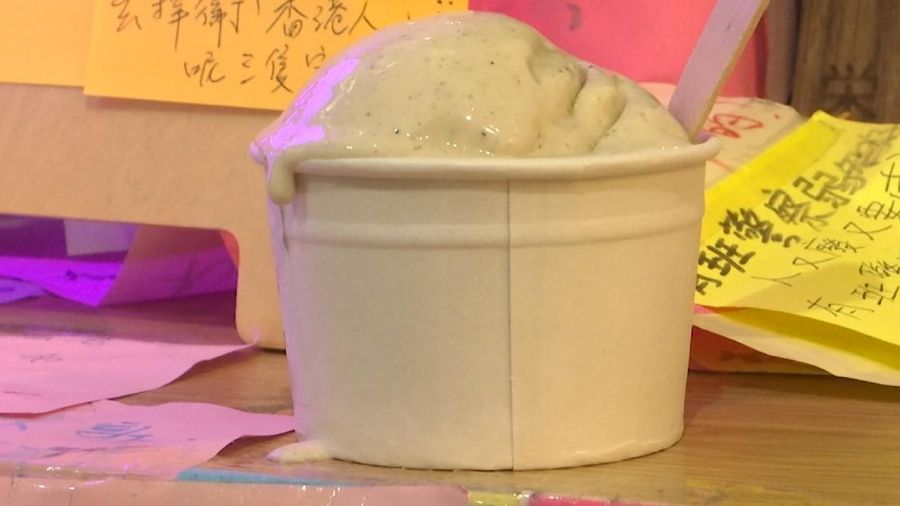 This May 4, 2020, image made from video shows a cup of tear gas flavor ice cream in Hong Kong. A Hong Kong ice cream shop has created this flavor using pepper, in memory of all the tear gas fired by the Hong Kong police in recent months. The flavor is a sign of support for the pro-democracy movement, which is seeking to regain its momentum during the coronavirus pandemic, the shop's owner said. (AP Photo)