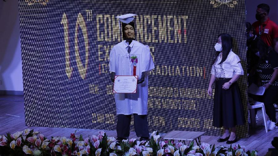 A picture of a student is seen on a tablet that is placed on a robot during an event they called 