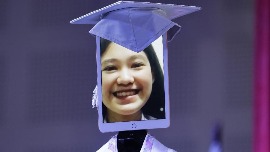 A picture of a student is seen on a tablet that is placed on a robot during an event they called 