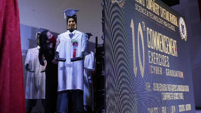 A picture of a student is seen on a tablet that is placed on a robot during an event they called 