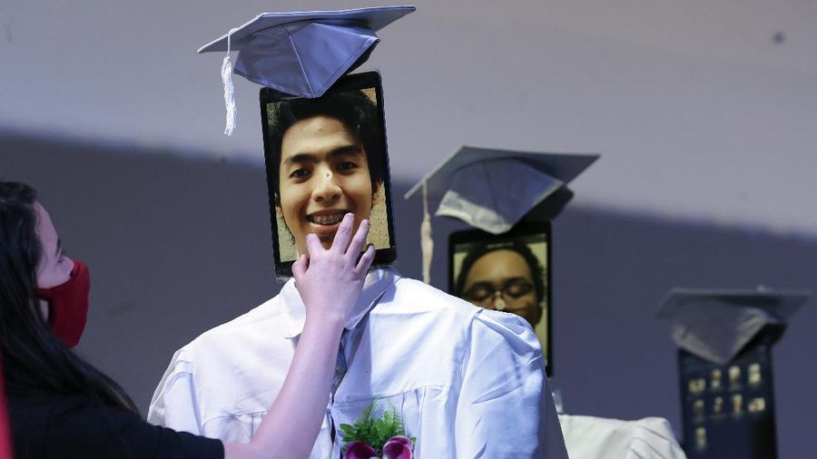 A picture of a student is seen on a tablet that is placed on a robot during an event they called 