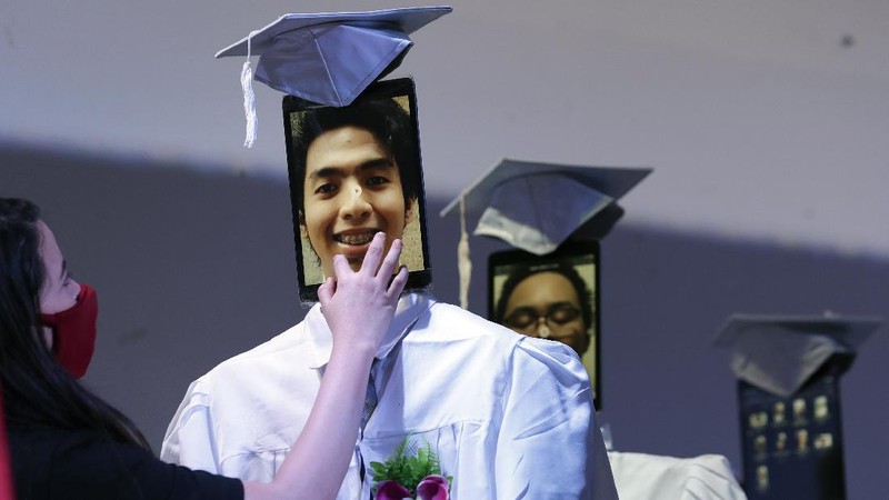 A picture of a student is seen on a tablet that is placed on a robot during an event they called 