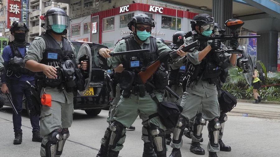 Riot police detain a protester during a demonstration against Beijing's national security legislation in Causeway Bay in Hong Kong, Sunday, May 24, 2020. Hong Kong police fired volleys of tear gas in a popular shopping district as hundreds took to the streets Sunday to march against China's proposed tough national security legislation for the city. (AP Photo/Vincent Yu)