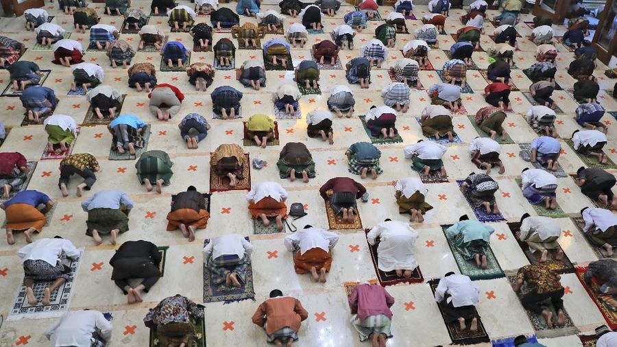 Indonesian Muslims pray spaced apart as they practice social distancing to curb the spread of the new coronavirus during an Eid al-Fitr prayer marking the end of the holy fasting month of Ramadan in Sidoarjo, East Java, Indonesia, Sunday, May 24, 2020. Millions of people in the world's largest Muslim nation are marking a muted and gloomy religious festival of Eid al-Fitr, the end of the fasting month of Ramadan _ a usually joyous three-day celebration that has been significantly toned down as coronavirus cases soar. (AP Photo/Trisnadi)