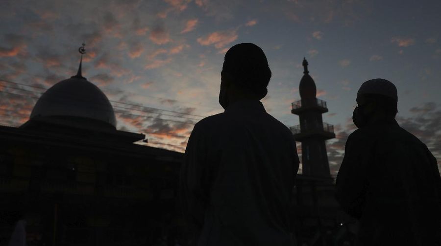 Indonesian Muslims attend an Eid al-Fitr prayer that marks the end of the holy fasting month of Ramadan amid fears of the new coronavirus outbreak in Bekasi on the outskirts of Jakarta, Indonesia Sunday, May 24, 2020. (AP Photo/Achmad Ibrahim)