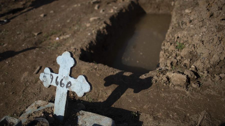 A cross with a number marks an empty grave at the Caju cemetery where many COVID-19 victims are being buried in Rio de Janeiro, Brazil, Wednesday, May 20, 2020. (AP Photo/Silvia Izquierdo)