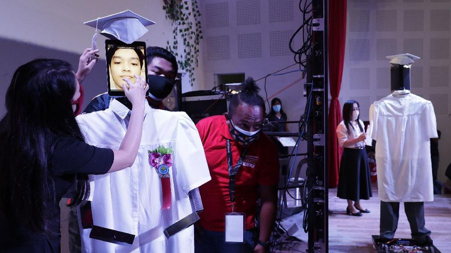 A picture of a student is seen on a tablet that is placed on a robot during an event they called 