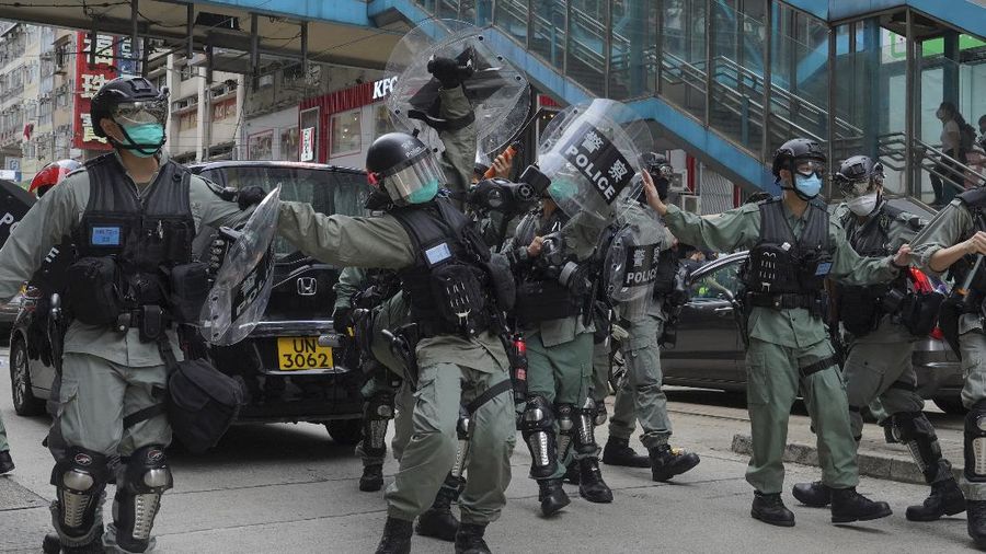 Riot police detain a protester during a demonstration against Beijing's national security legislation in Causeway Bay in Hong Kong, Sunday, May 24, 2020. Hong Kong police fired volleys of tear gas in a popular shopping district as hundreds took to the streets Sunday to march against China's proposed tough national security legislation for the city. (AP Photo/Vincent Yu)