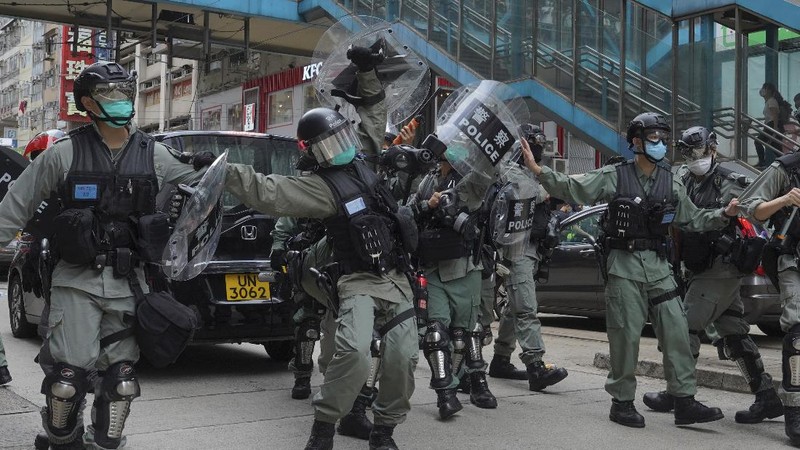 Riot police detain a protester during a demonstration against Beijing's national security legislation in Causeway Bay in Hong Kong, Sunday, May 24, 2020. Hong Kong police fired volleys of tear gas in a popular shopping district as hundreds took to the streets Sunday to march against China's proposed tough national security legislation for the city. (AP Photo/Vincent Yu)