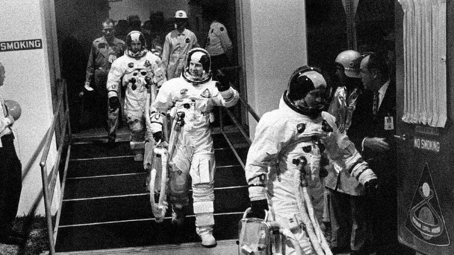FILE - In this Dec. 21, 1968 file photo, Apollo 8 astronauts, suited up and ready to go, walk to a van heading for their Saturn V rocket for their moon orbit mission from Cape Kennedy, Fla. Leading the way is Commander Frank Borman, followed by James A. Lovell and William A. Anders. (AP Photo)