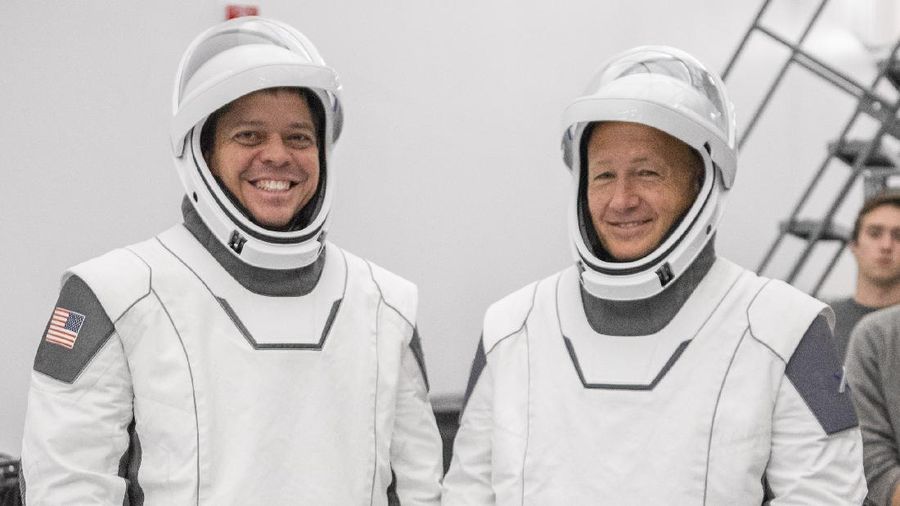 This Thursday, March 19, 2020 photo made available by SpaceX shows NASA astronauts Bob Behnken and Doug Hurley during flight simulator testing at the Kennedy Space Center in Cape Canaveral, Fla., with SpaceX teams in Firing Room 4 at NASA's Kennedy Space Center, SpaceX's Mission Control in Hawthorne, Calif., and NASA flight controllers in Mission Control Houston, for a full simulation of launch and docking of the Crew Dragon spacecraft. (SpaceX via AP)
