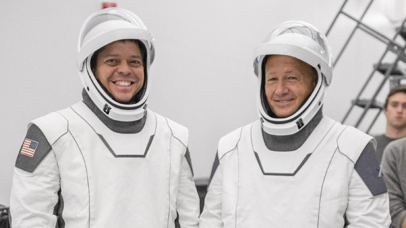 This Thursday, March 19, 2020 photo made available by SpaceX shows NASA astronauts Bob Behnken and Doug Hurley during flight simulator testing at the Kennedy Space Center in Cape Canaveral, Fla., with SpaceX teams in Firing Room 4 at NASA's Kennedy Space Center, SpaceX's Mission Control in Hawthorne, Calif., and NASA flight controllers in Mission Control Houston, for a full simulation of launch and docking of the Crew Dragon spacecraft. (SpaceX via AP)