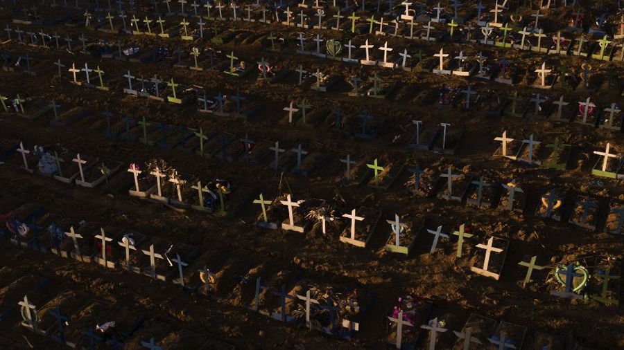 Crosses mark the graves of those who have passed away since early April, filling a new section of the Nossa Senhora Aparecida public cemetery amid the new coronavirus pandemic in Manaus, Brazil, Sunday, May 16, 2020. The new area was opened last month to cope with a sudden surge in deaths in the city, though most of the deceased were not tested for COVID-19. (AP Photo/Felipe Dana)