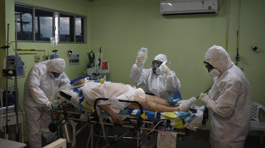 Emergency workers transfer a COVID-19 patient to a hospital in Manaus, Brazil, Friday, May 15, 2020. Per capita, Manaus is Brazil's major city hardest hit by COVID-19. (AP Photo/Felipe Dana)