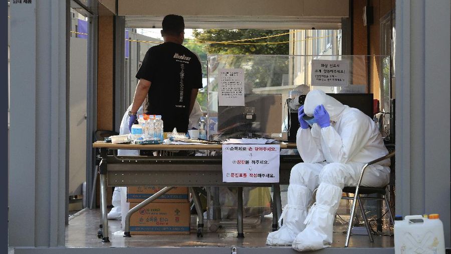 A woman wearing a face mask walks by a board displaying the world banks' notes at a subway station in Seoul, South Korea, Thursday, May 28, 2020. South Korea’s central bank lowered its policy rate to an all-time low of 0.5% to soften the pandemic’s shock to the country’s trade-dependent economy, which it says may shrink for the first time in 22 years. (AP Photo/Ahn Young-joon)