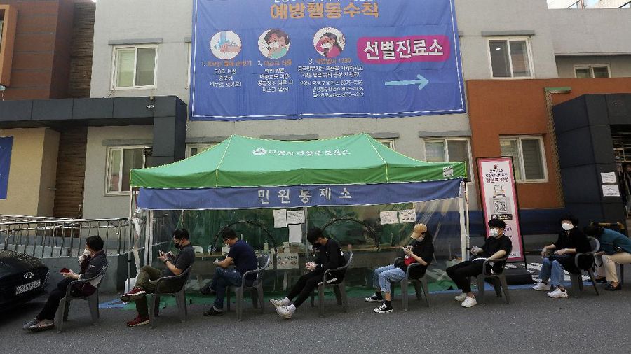 A woman wearing a face mask walks by a board displaying the world banks' notes at a subway station in Seoul, South Korea, Thursday, May 28, 2020. South Korea’s central bank lowered its policy rate to an all-time low of 0.5% to soften the pandemic’s shock to the country’s trade-dependent economy, which it says may shrink for the first time in 22 years. (AP Photo/Ahn Young-joon)