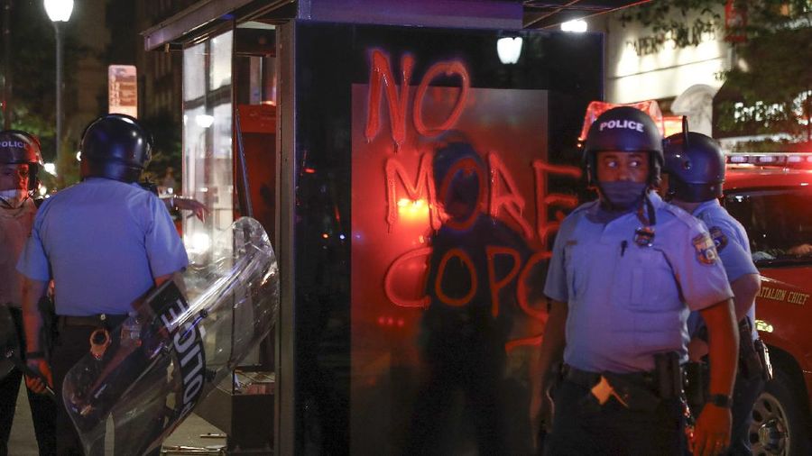 People hold signs during a protest over the death of George Floyd in Chicago, Saturday, May 30, 2020. Protests were held throughout the country over the death of Floyd, a black man who died after being restrained by Minneapolis police officers on May 25.(AP Photo/Nam Y. Huh)