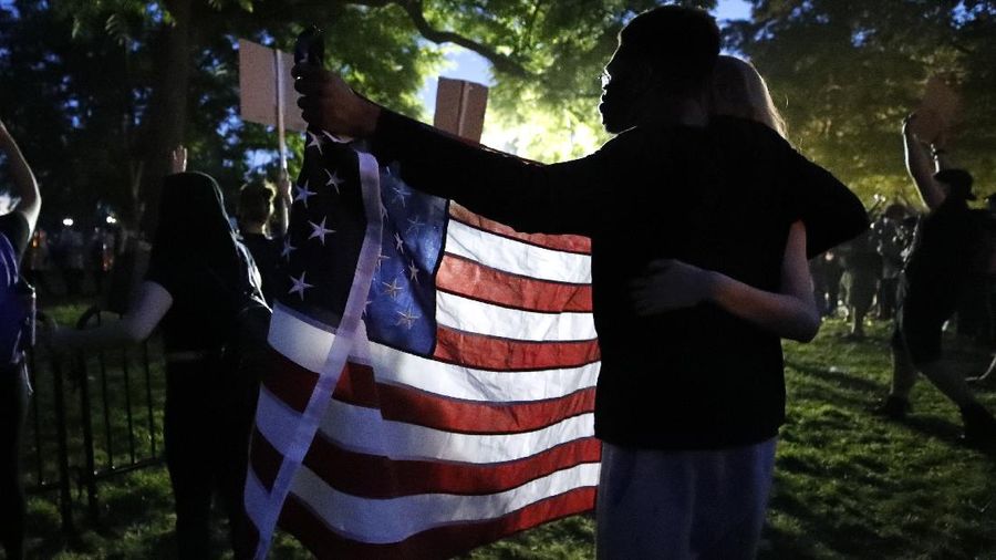 Crowds of protesters walk across the Monroe Street Bridge and up the hill to the Spokane County Courthouse, Sunday, May 31, 2020, in Spokane, Wash. during a protest to express anger over the death of George Floyd in Minneapolis. (Jesse Tinsley/The Spokesman-Review via AP)
