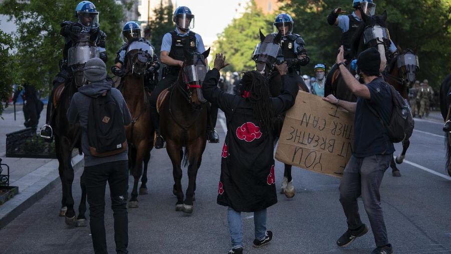 Demonstrators gather to protest the death of George Floyd, Monday, June 1, 2020, near the White House in Washington. Floyd died after being restrained by Minneapolis police officers. (AP Photo/Evan Vucci)