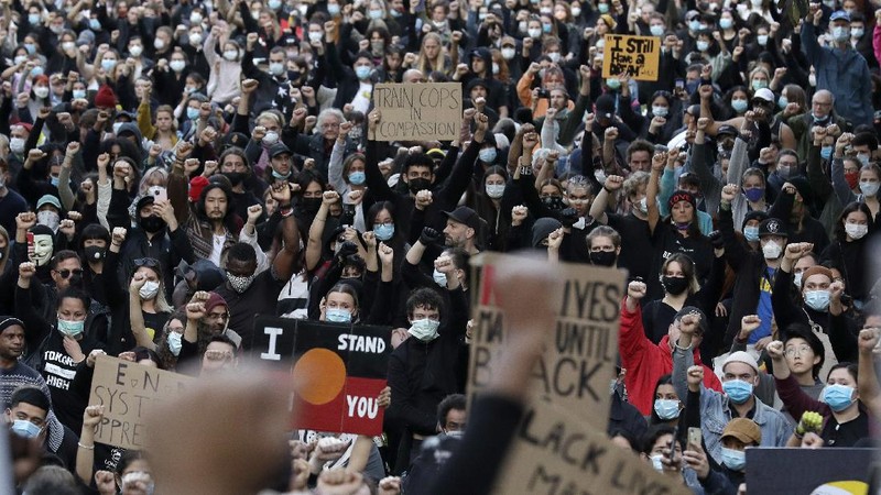 Protestors march in Sydney, Saturday, June 6, 2020, to support the cause of U.S. protests over the death of George Floyd. Black Lives Matter protests across Australia proceeded mostly peacefully as thousands of demonstrators in state capitals honored the memory of Floyd and protested the deaths of indigenous Australians in custody. (AP Photo/Rick Rycroft)