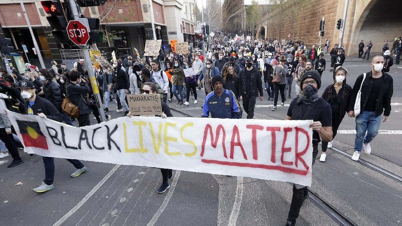 Protestors march in Sydney, Saturday, June 6, 2020, to support the cause of U.S. protests over the death of George Floyd. Black Lives Matter protests across Australia proceeded mostly peacefully as thousands of demonstrators in state capitals honored the memory of Floyd and protested the deaths of indigenous Australians in custody. (AP Photo/Rick Rycroft)