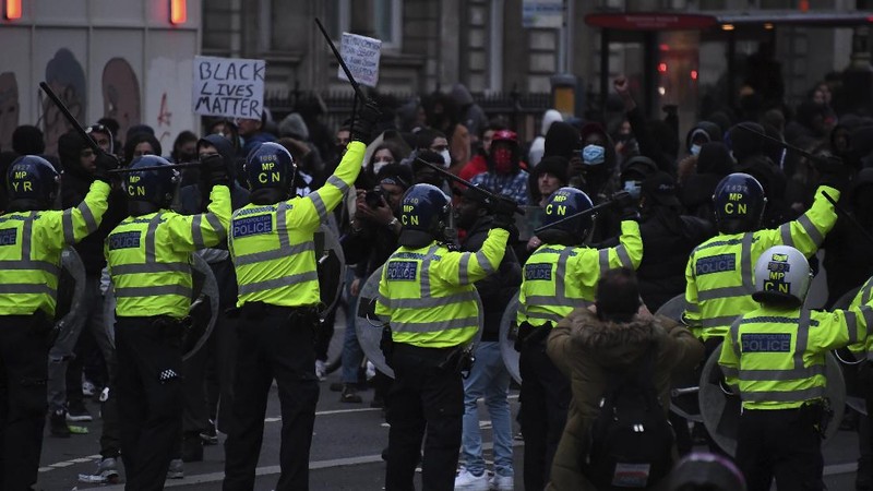 People take part in a Black Lives Matter protest rally in Manchester, England, Sunday, June 7, 2020, in response to the recent killing of George Floyd by police officers in Minneapolis, USA, that has led to protests in many countries and across the US. (Danny Lawson/PA via AP)