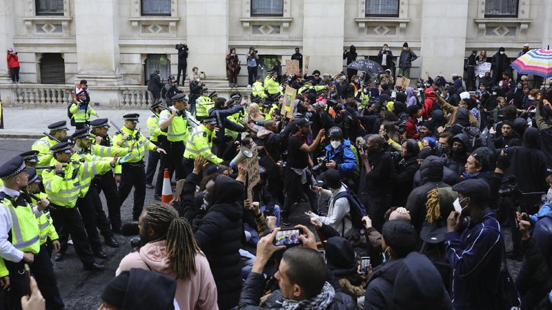 People take part in a Black Lives Matter protest rally in Manchester, England, Sunday, June 7, 2020, in response to the recent killing of George Floyd by police officers in Minneapolis, USA, that has led to protests in many countries and across the US. (Danny Lawson/PA via AP)