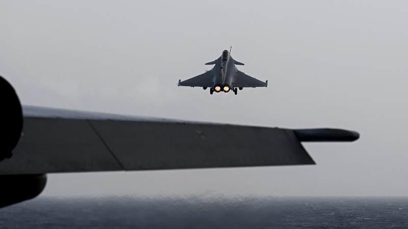A Rafale fighter jet lands on deck of the French aircraft carrier Charles de Gaulle, off the coast of the city of Hyeyres, southern France, Thursday, Jan. 23, 2020. France deploys the Charles de Gaulle aircraft carrier for a three-month mission to support International military operations in the Middle East, French President Emmanuel Macron said. (Philippe Lopez/Pool Photo via AP)