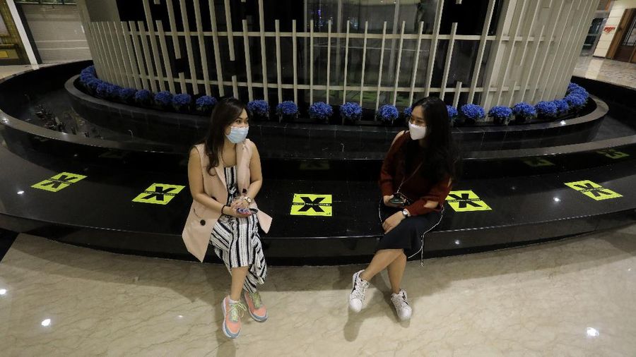 Staff wear face shields as a precaution against the new coronavirus at the reception desk of Senayan City shopping mall in Jakarta, Indonesia, Tuesday, June 9, 2020. As Indonesia's overall virus caseload continues to rise, the capital city has moved to restore normalcy by lifting some restrictions this week, saying that the spread of the virus in the city of 11 million has slowed after peaking in mid-April. (AP Photo/Dita Alangkara)