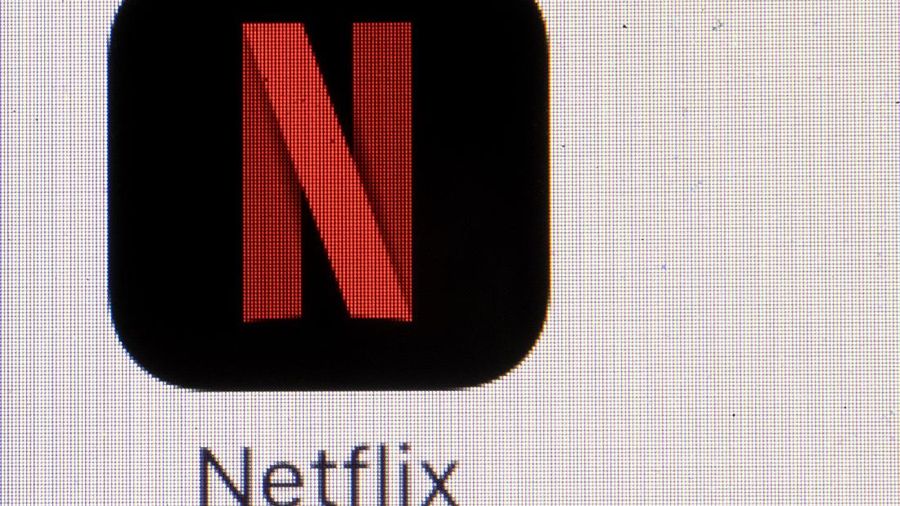 This Monday, July 17, 2017, photo shows the Netflix logo on an iPhone. Netflix, Inc. reports earnings Monday, Oct. 16, 2017. (AP Photo/Matt Rourke)