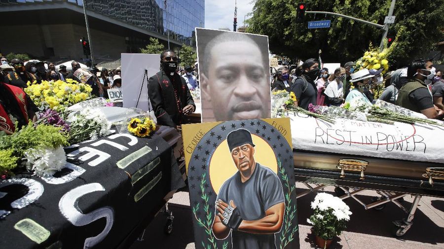 Mourners pass by the casket of George Floyd during a public visitation for Floyd at the Fountain of Praise church Monday, June 8, 2020, in Houston. (AP Photo/David J. Phillip, Pool)