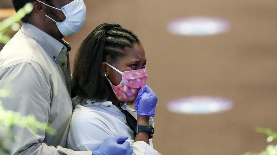 Mourners pass by the casket of George Floyd during a public visitation for Floyd at the Fountain of Praise church Monday, June 8, 2020, in Houston. (AP Photo/David J. Phillip, Pool)