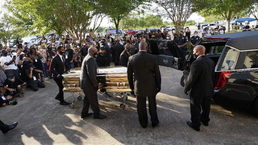 Mourners pass by the casket of George Floyd during a public visitation for Floyd at the Fountain of Praise church Monday, June 8, 2020, in Houston. (AP Photo/David J. Phillip, Pool)
