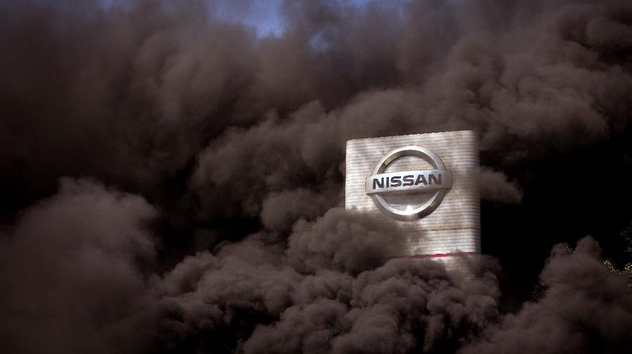 Smoke rises over the Nissan factory as workers burn tires during a protest in Barcelona, Spain, Thursday, May 28, 2020. Japanese carmaker Nissan Motor Co. has decided to close its manufacturing plans in the northeastern Catalonia region, resulting in the loss of some 3,000 direct jobs. (AP Photo/Emilio Morenatti)