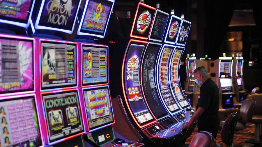 Chairs sit on pallets as some are being removed from electronic slot machines to maintain social distancing between players at a closed Caesars Palace hotel and casino Thursday, May 21, 2020, in Las Vegas. Casino operators in Las Vegas are awaiting word when they will be able to reopen after a shutdown during the coronavirus outbreak. (AP Photo/John Locher)