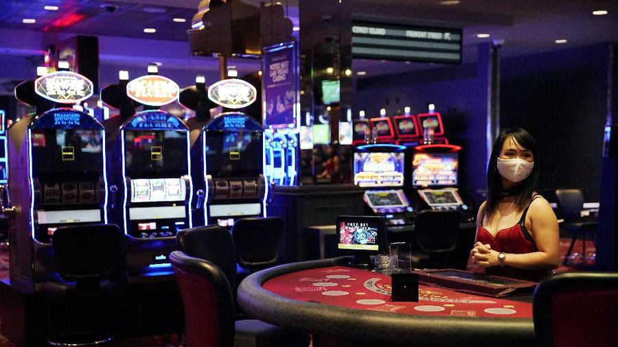 Chairs sit on pallets as some are being removed from electronic slot machines to maintain social distancing between players at a closed Caesars Palace hotel and casino Thursday, May 21, 2020, in Las Vegas. Casino operators in Las Vegas are awaiting word when they will be able to reopen after a shutdown during the coronavirus outbreak. (AP Photo/John Locher)