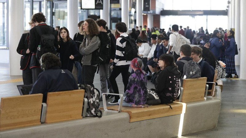 Pedestrians walk past a billboard featuring Prime Minister Jacinda Ardern with the word Aroha, meaning love, in Christchurch, New Zealand, Monday, June 8, 2020. New Zealand appears to have completely eradicated the coronavirus, at least for now, after health officials said Monday the last known infected person had recovered. (AP Photo/Mark Baker)