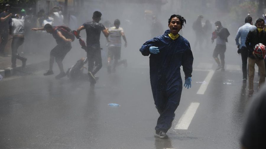 Nepalese police use water cannon to disperse youth who gathered for a protest near prime minister's residence demanding better handling of the COVID-19 pandemic in Kathmandu, Nepal, Thursday, June 11, 2020. About 1000 protesters had gathered demanding increased testing and alleging corruption by government officials while purchasing equipment and testing kits. (AP Photo/Niranjan Shrestha)