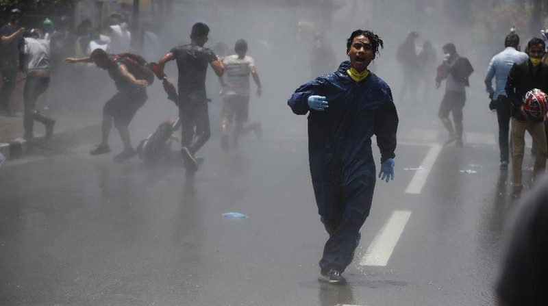 Nepalese police use water cannon to disperse youth who gathered for a protest near prime minister's residence demanding better handling of the COVID-19 pandemic in Kathmandu, Nepal, Thursday, June 11, 2020. About 1000 protesters had gathered demanding increased testing and alleging corruption by government officials while purchasing equipment and testing kits. (AP Photo/Niranjan Shrestha)