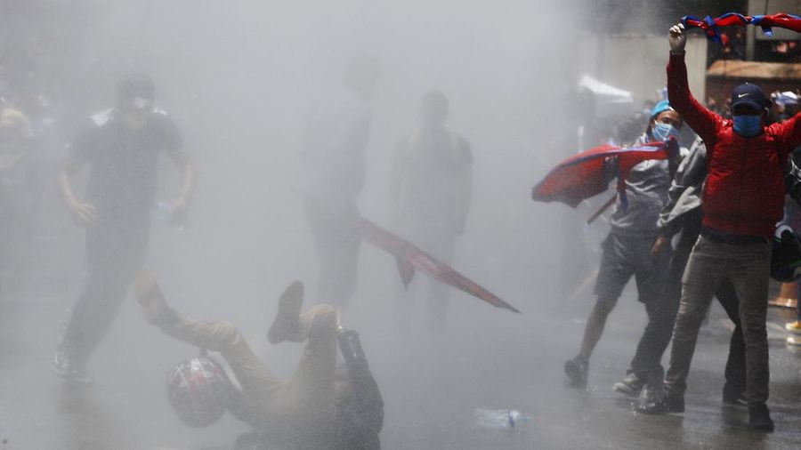 Nepalese police use water cannon to disperse youth who gathered for a protest near prime minister's residence demanding better handling of the COVID-19 pandemic in Kathmandu, Nepal, Thursday, June 11, 2020. About 1000 protesters had gathered demanding increased testing and alleging corruption by government officials while purchasing equipment and testing kits. (AP Photo/Niranjan Shrestha)