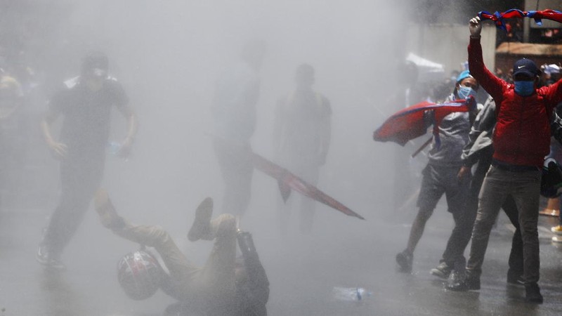 Nepalese police use water cannon to disperse youth who gathered for a protest near prime minister's residence demanding better handling of the COVID-19 pandemic in Kathmandu, Nepal, Thursday, June 11, 2020. About 1000 protesters had gathered demanding increased testing and alleging corruption by government officials while purchasing equipment and testing kits. (AP Photo/Niranjan Shrestha)