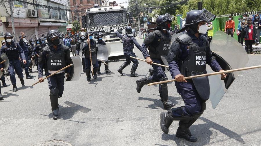 Nepalese police use water cannon to disperse youth who gathered for a protest near prime minister's residence demanding better handling of the COVID-19 pandemic in Kathmandu, Nepal, Thursday, June 11, 2020. About 1000 protesters had gathered demanding increased testing and alleging corruption by government officials while purchasing equipment and testing kits. (AP Photo/Niranjan Shrestha)