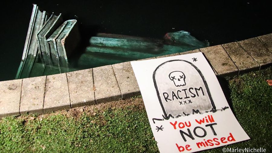 Activists bring down the Christopher Columbus statue in front of the Capitol, Wednesday, June 10, 2020, in St. Paul, Minn. A rope was thrown around the 10-foot bronze statue and it was pulled off its stone pedestal. The protesters included Dakota and Ojibwe Indians who consider Columbus as a symbol of genocide against Native Americans. State Patrol troopers in helmets stood by at a distance but did not try to stop the protesters. (Leila Navidi/Star Tribune via AP)