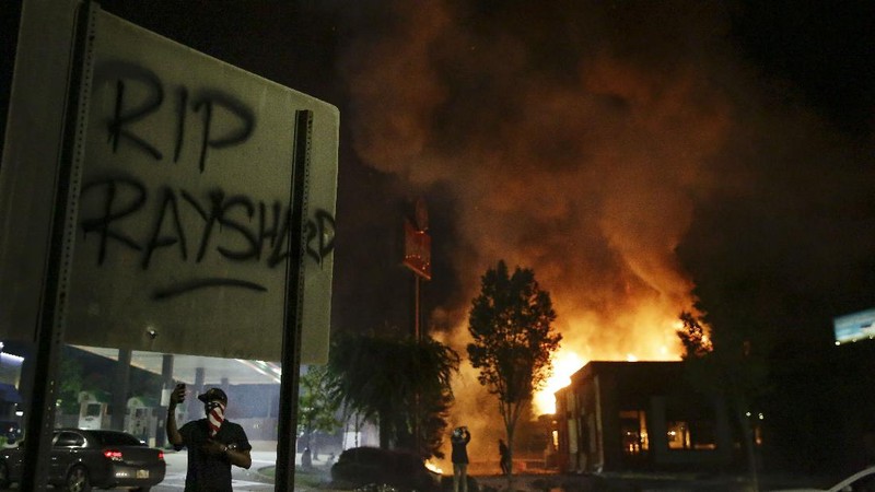 Police attempt to control protestors outside a Wendy's restaurant Saturday, June 13, 2020 in Atlanta. Georgia authorities said Saturday a man was shot and killed in a late night struggle with Atlanta police outside a fast food restaurant after he failed a field sobriety test and resisted arrest. (Ben Gray/Atlanta Journal-Constitution via AP)