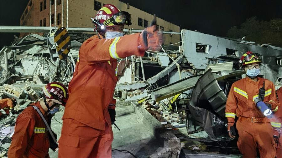 Firefighters look for victims in damaged buildings in the aftermath of a tanker truck explosion near a highway in Wenling in eastern China's Zhejiang province early Sunday, June 14, 2020. More than a dozen were killed and others injured after the tanker truck veered off the Shenyang-Haikou Expressway after the explosion. (Chinatopix via AP)