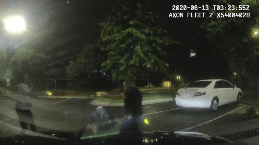 This screen grab taken from body camera video provided by the Atlanta Police Department shows Rayshard Brooks speaking with Officer Garrett Rolfe in the parking lot of a Wendy's restaurant, late Friday, June 12, 2020, in Atlanta. Rolfe has been fired following the fatal shooting of Brooks and a second officer has been placed on administrative duty. (Atlanta Police Department via AP)