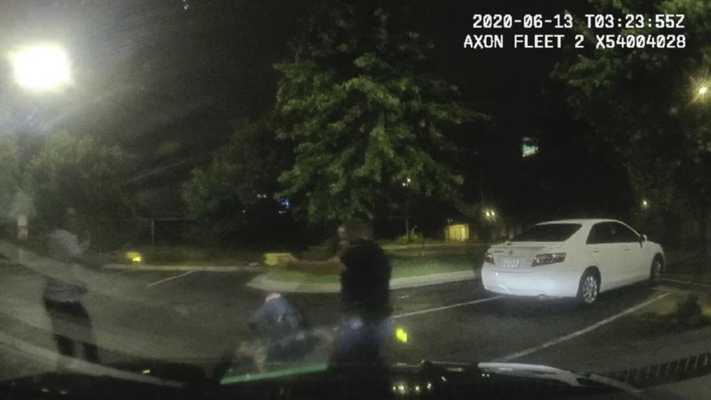 This screen grab taken from body camera video provided by the Atlanta Police Department shows Rayshard Brooks speaking with Officer Garrett Rolfe in the parking lot of a Wendy's restaurant, late Friday, June 12, 2020, in Atlanta. Rolfe has been fired following the fatal shooting of Brooks and a second officer has been placed on administrative duty. (Atlanta Police Department via AP)